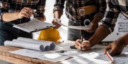 People working over a blueprint