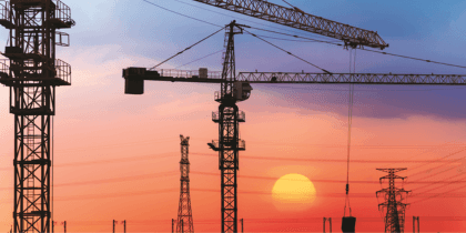 Cranes overlooking sunset