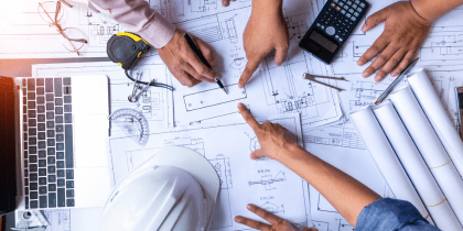 People working over a blueprint