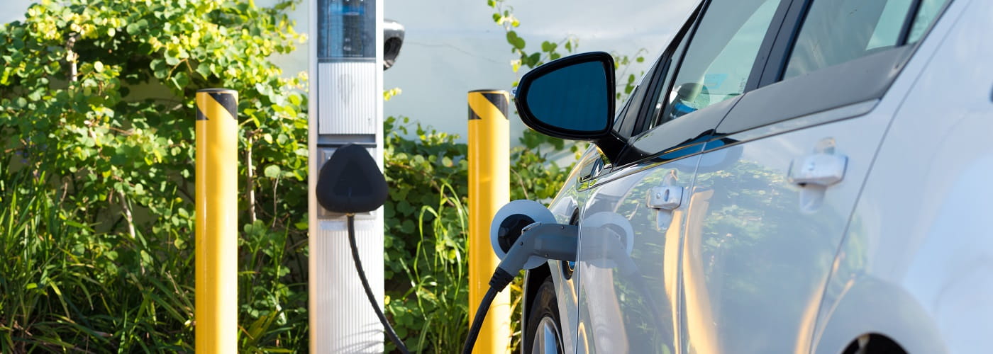 close up of electric car charging  on sunny day