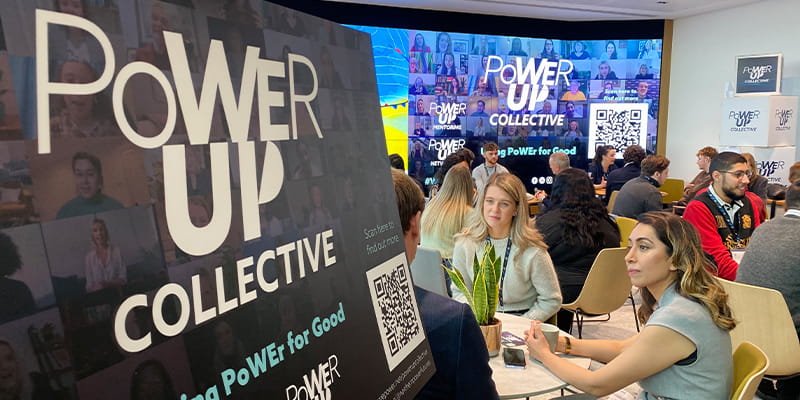 People sat at tables at Power Up Collective event
