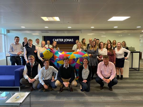 Carter Jonas Oxford team next to OxTrail's 2024 sculpture